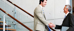 Two men shaking hands on stairway