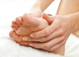 Massaging essential oils into foot