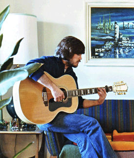 Man playing Guild 12-string guitar